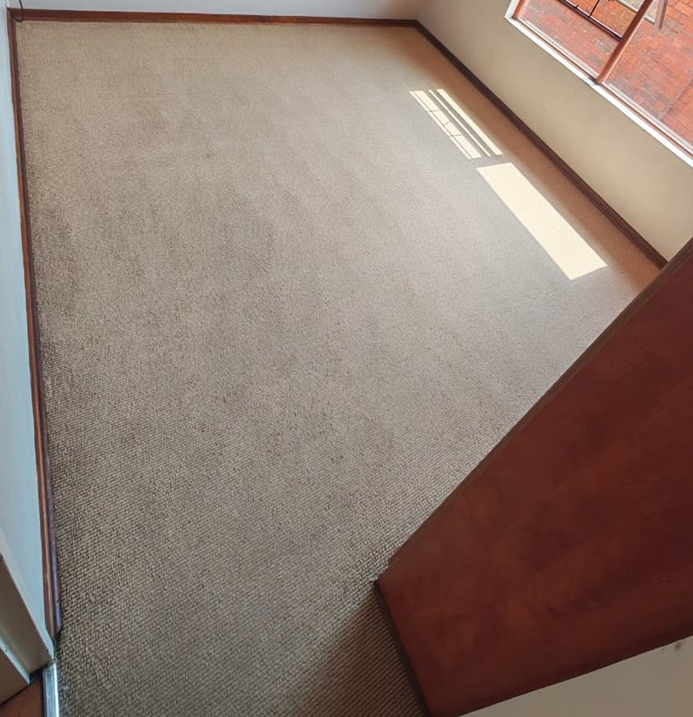 The same bedroom carpet after MooiMop hot-water extraction, colour restored and evenly clean